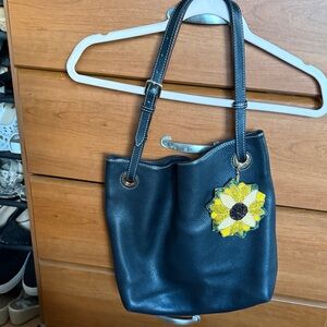 Vintage Dooney &Bourke Elegant Black Leather Tote Bag with Sunflower Charm